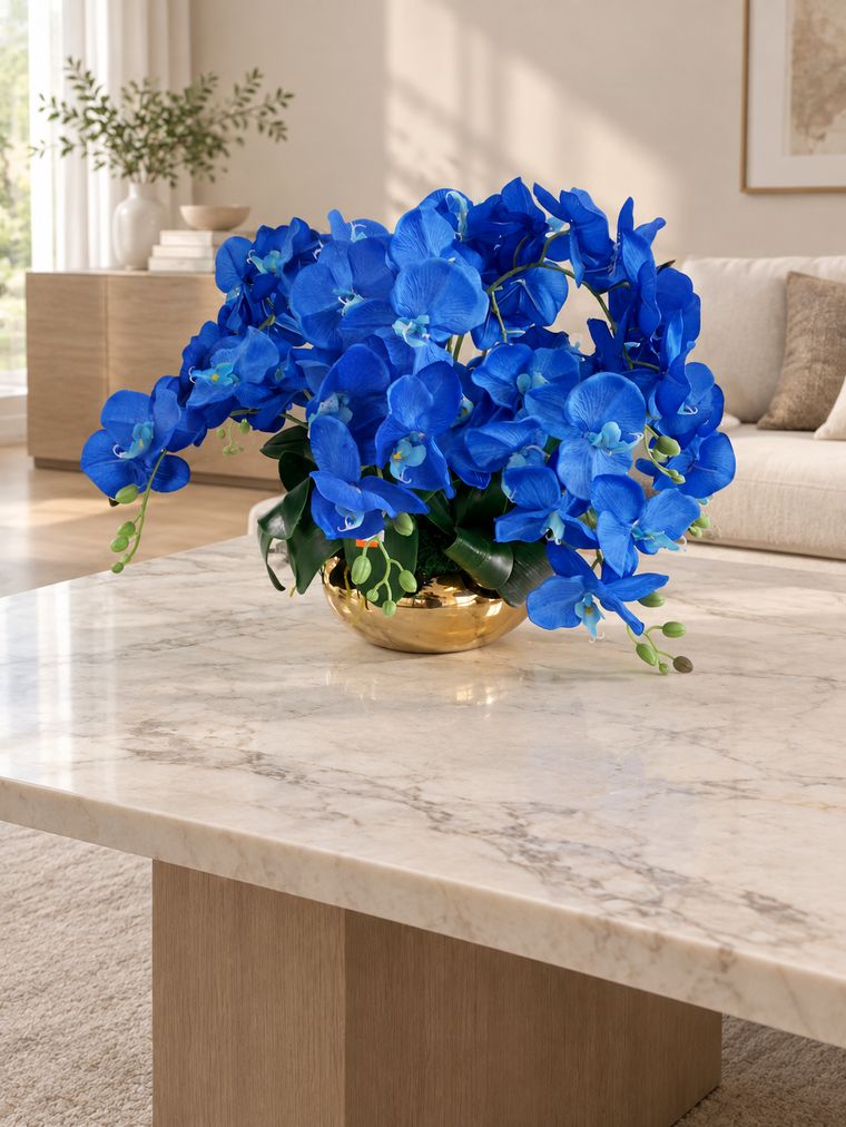 Blue orchid centerpiece in gold bowl