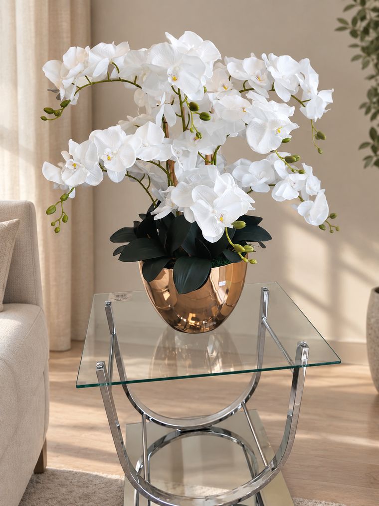 White orchid arrangement in copper vase