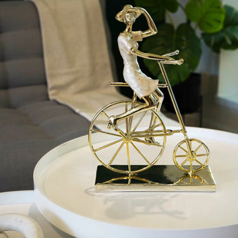 Gold Plated Woman on Bicycle